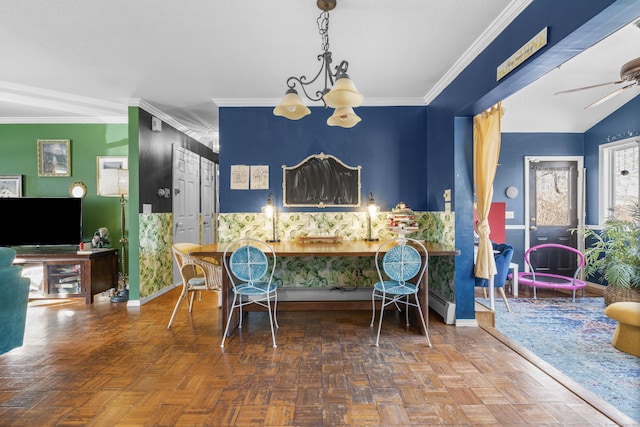 dining room with baseboards, ornamental molding, and ceiling fan with notable chandelier