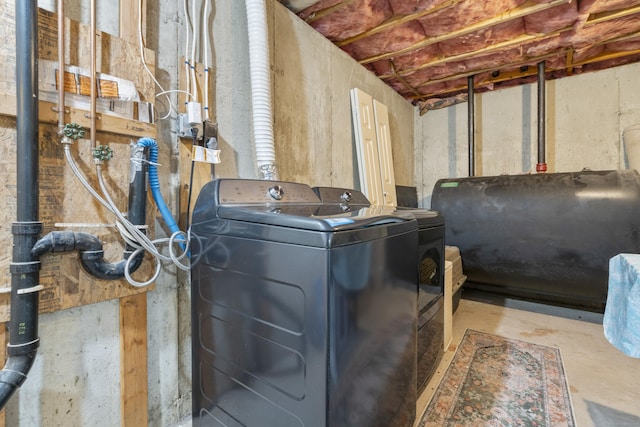 washroom with laundry area, independent washer and dryer, and heating fuel