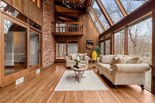 sunroom / solarium featuring a skylight, visible vents, and a notable chandelier