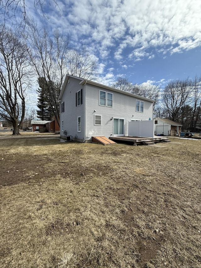 rear view of house featuring a wooden deck