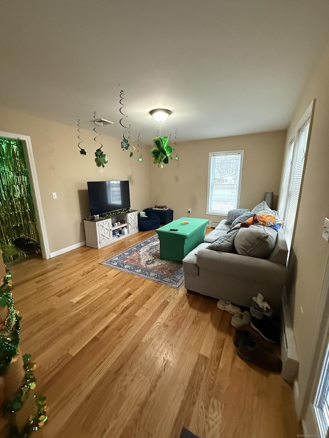 living room featuring baseboards and wood finished floors