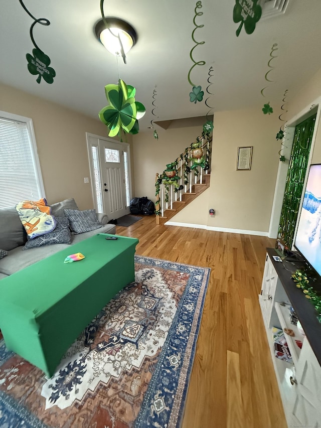 rec room featuring visible vents, baseboards, and wood finished floors