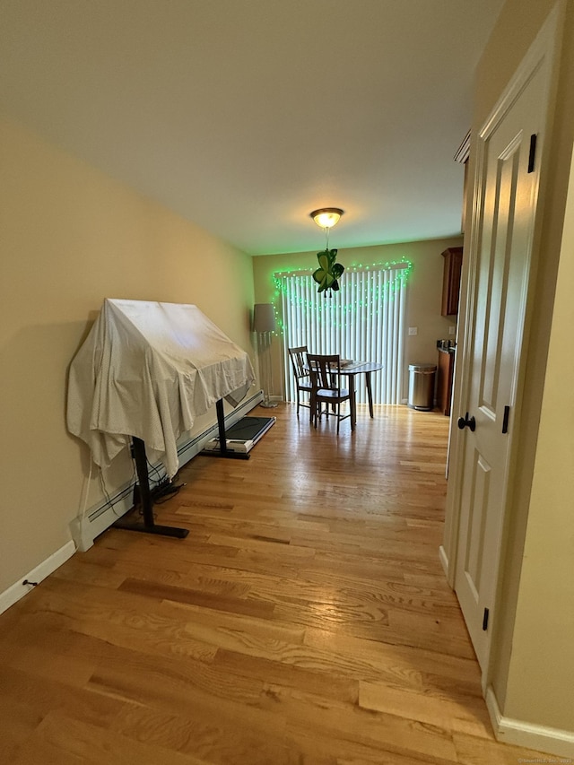 bedroom featuring baseboards and light wood finished floors