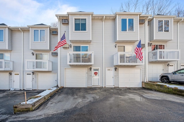 view of property featuring a garage and driveway