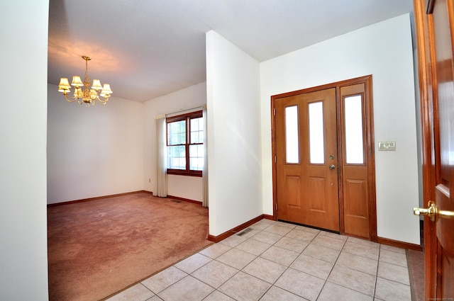 foyer with visible vents, light carpet, light tile patterned flooring, a chandelier, and baseboards