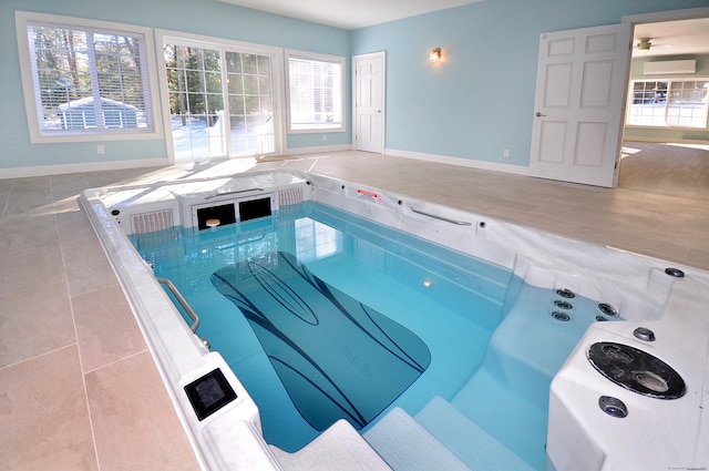 view of swimming pool featuring an indoor hot tub and a wall unit AC