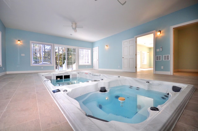 view of pool featuring ceiling fan and an indoor hot tub