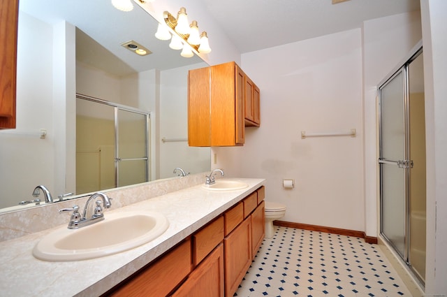 bathroom featuring baseboards, a sink, and a shower stall