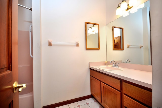 full bathroom with vanity, baseboards, and tile patterned floors