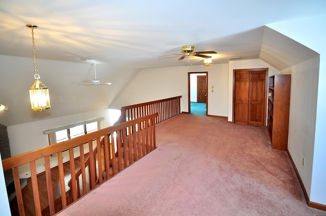 bonus room with carpet floors, lofted ceiling, visible vents, a ceiling fan, and baseboards