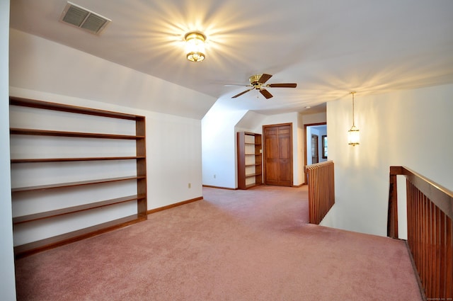 bonus room with light carpet, vaulted ceiling, visible vents, and baseboards