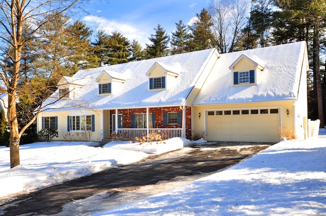 cape cod-style house featuring a garage, covered porch, and brick siding