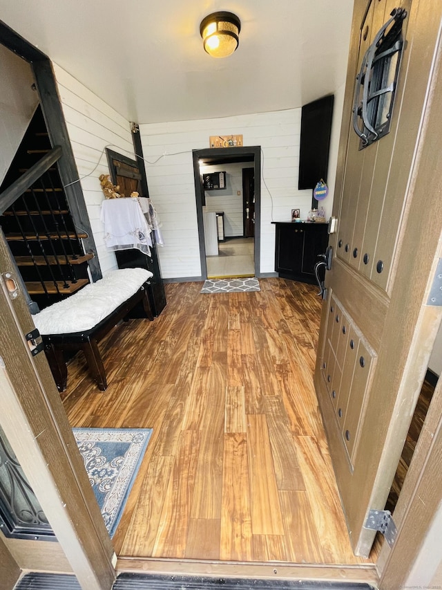 670 Wauregan Rd, Brooklyn, CT 06234 - hallway featuring light wood finished floors and wooden walls