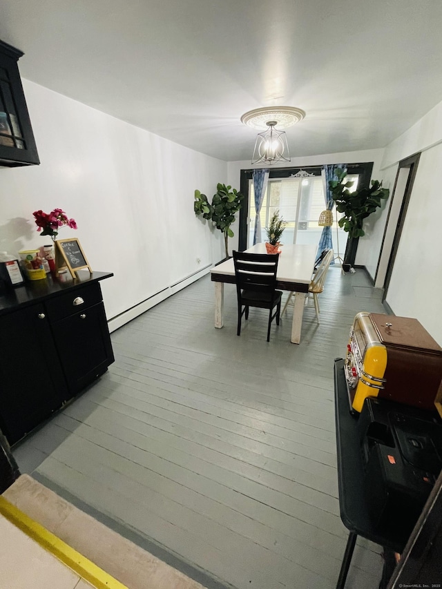 670 Wauregan Rd, Brooklyn, CT 06234 - dining space with baseboard heating, wood-type flooring, and a chandelier