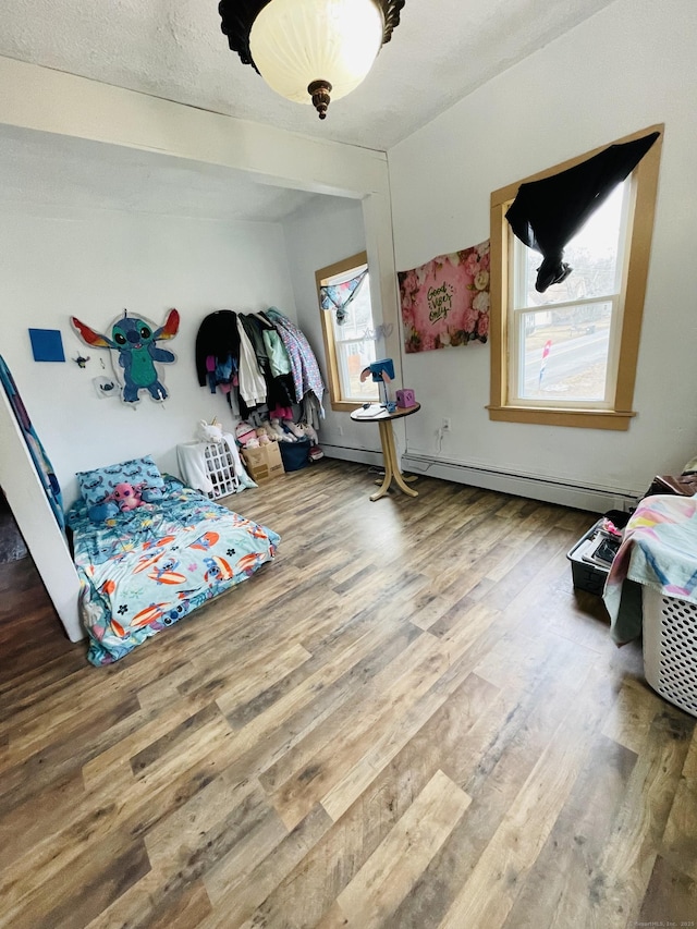 670 Wauregan Rd, Brooklyn, CT 06234 - bedroom featuring wood finished floors and baseboard heating