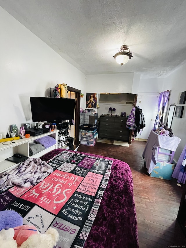 670 Wauregan Rd, Brooklyn, CT 06234 - bedroom with a textured ceiling and wood finished floors