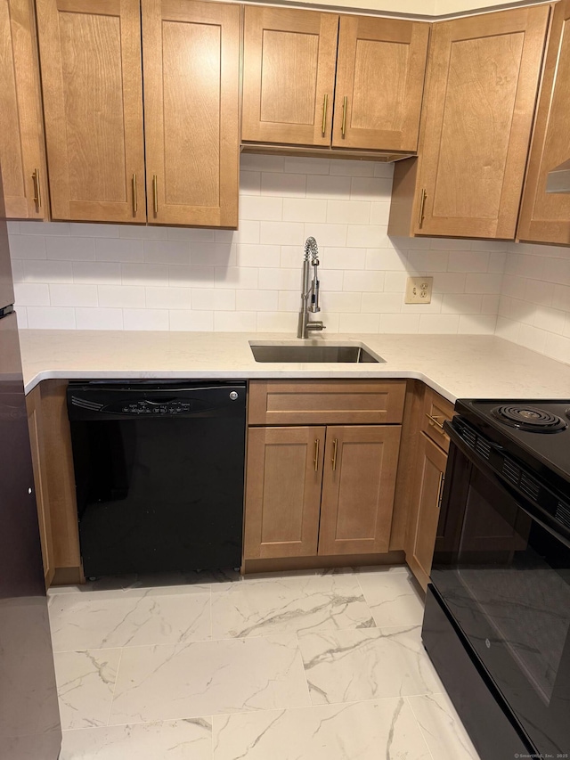 kitchen with marble finish floor, light countertops, decorative backsplash, a sink, and black appliances