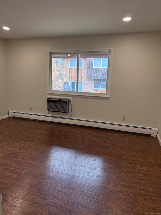 spare room with dark wood-style floors, recessed lighting, and a healthy amount of sunlight