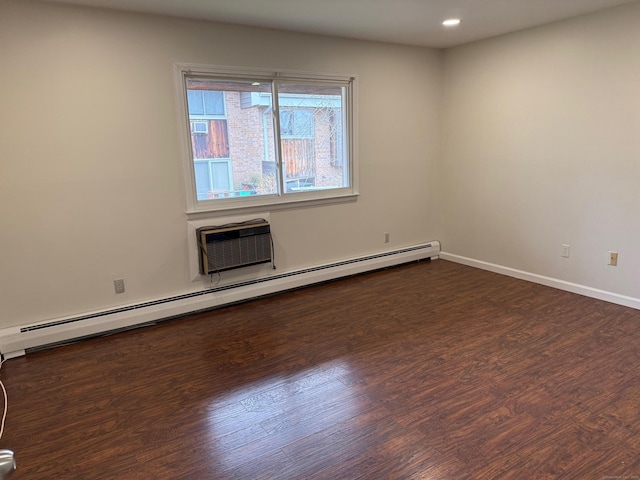 unfurnished room with dark wood-style flooring, recessed lighting, baseboard heating, a wall mounted AC, and baseboards