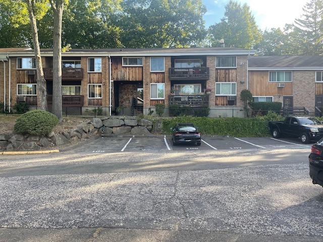 view of building exterior with uncovered parking