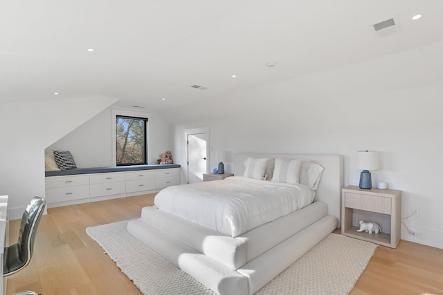 bedroom with lofted ceiling, light wood-style flooring, visible vents, and recessed lighting