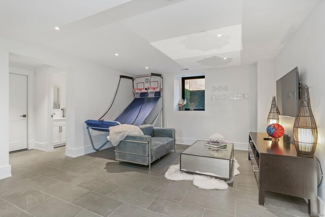 tiled living room featuring baseboards and recessed lighting