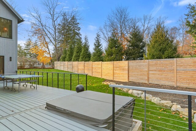 wooden deck with outdoor dining space, a lawn, and a fenced backyard