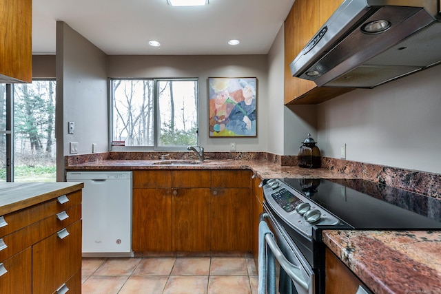 kitchen with stainless steel electric range oven, white dishwasher, brown cabinets, and under cabinet range hood