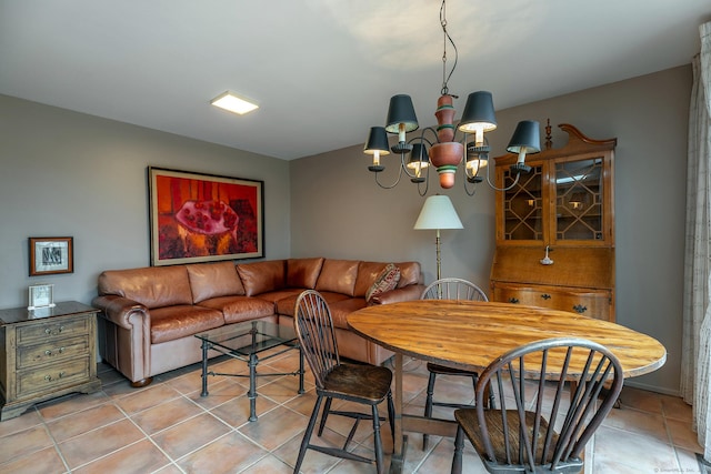 dining space featuring a notable chandelier and light tile patterned floors