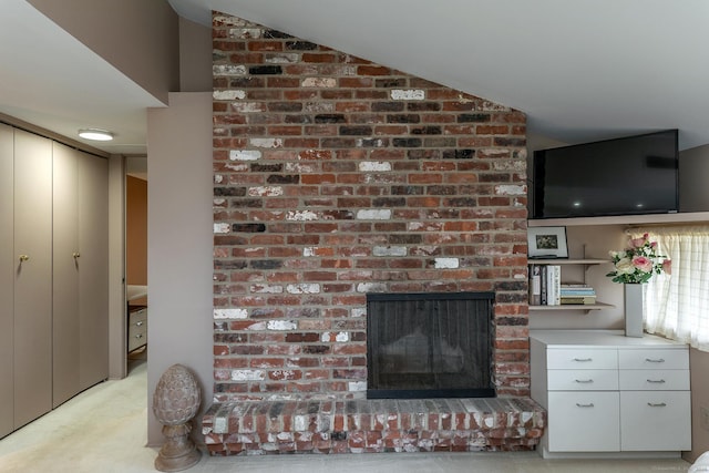 living area featuring lofted ceiling, a fireplace, and light carpet