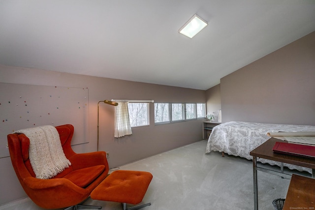 carpeted bedroom with lofted ceiling