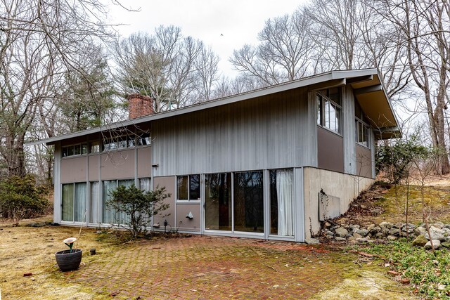 back of property with a chimney