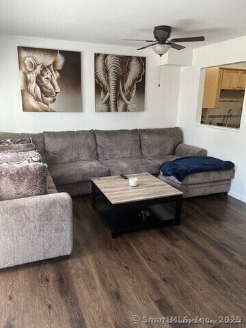 living room featuring ceiling fan and wood finished floors