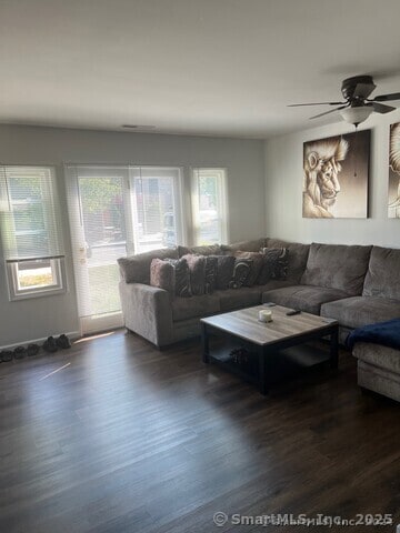 living room with ceiling fan and wood finished floors