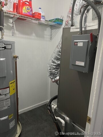 utility room with water heater and heating unit