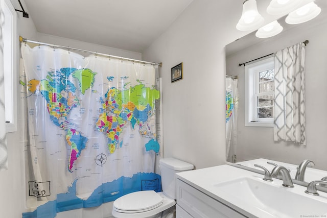 bathroom with curtained shower, vanity, and toilet