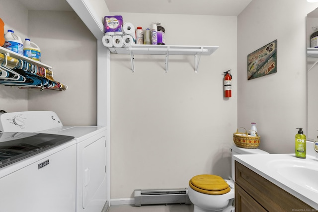 laundry room with laundry area, a baseboard radiator, a sink, and washing machine and dryer