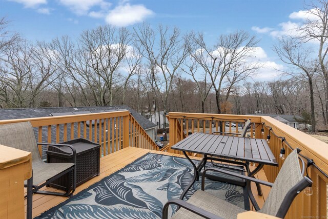 wooden deck featuring outdoor dining area