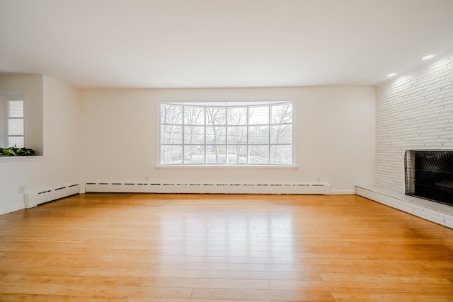 unfurnished living room featuring light wood-type flooring and a fireplace