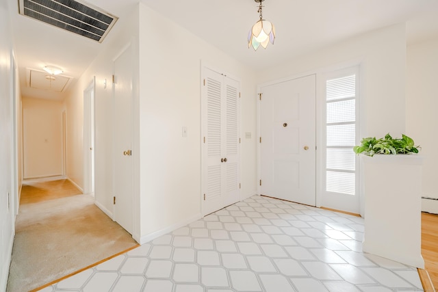 entrance foyer featuring baseboard heating, baseboards, visible vents, and light floors