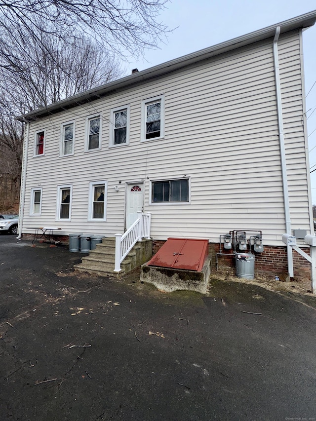 rear view of property featuring entry steps