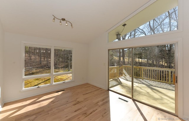 sunroom / solarium with visible vents and vaulted ceiling