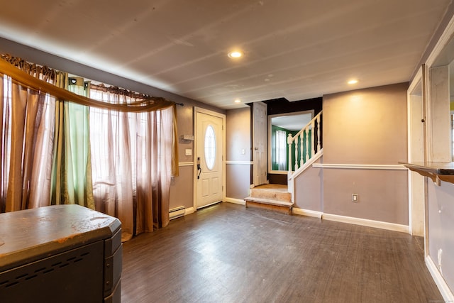 interior space featuring dark wood-style flooring, baseboards, stairway, and baseboard heating