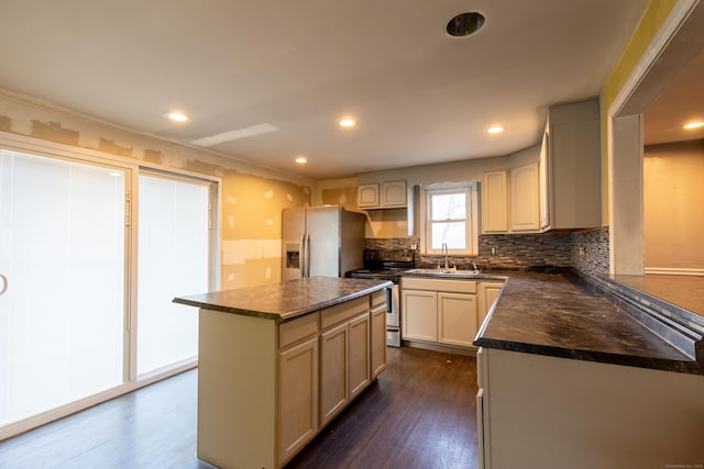 kitchen with dark wood finished floors, stainless steel appliances, dark countertops, recessed lighting, and backsplash