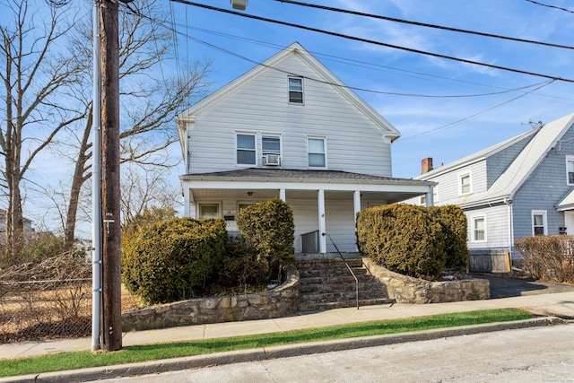 view of front of property with covered porch and fence