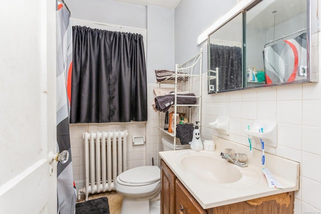 bathroom with toilet, tile walls, radiator heating unit, and vanity