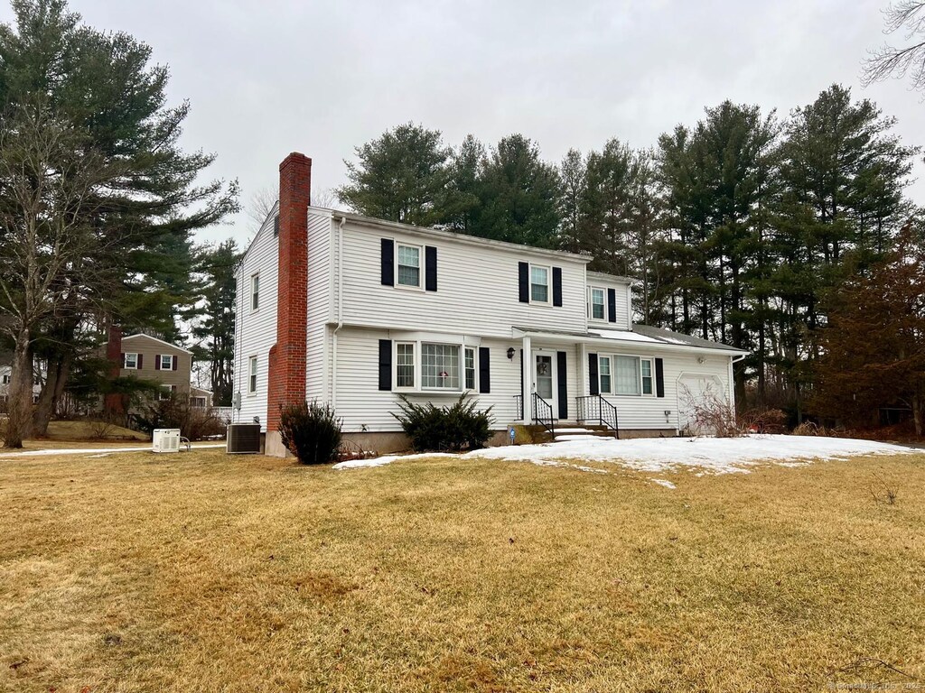 343 Merline Rd, Vernon, CT 06066 - view of front facade featuring a front lawn, a chimney, and central AC unit