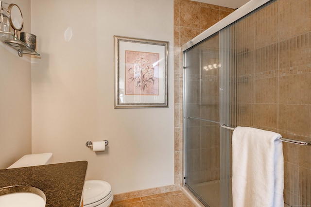 full bathroom with a stall shower, vanity, toilet, and tile patterned floors