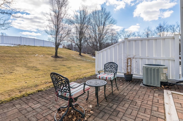 view of patio featuring central AC and fence