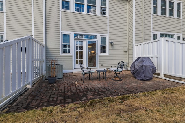 rear view of house with a patio area and central AC